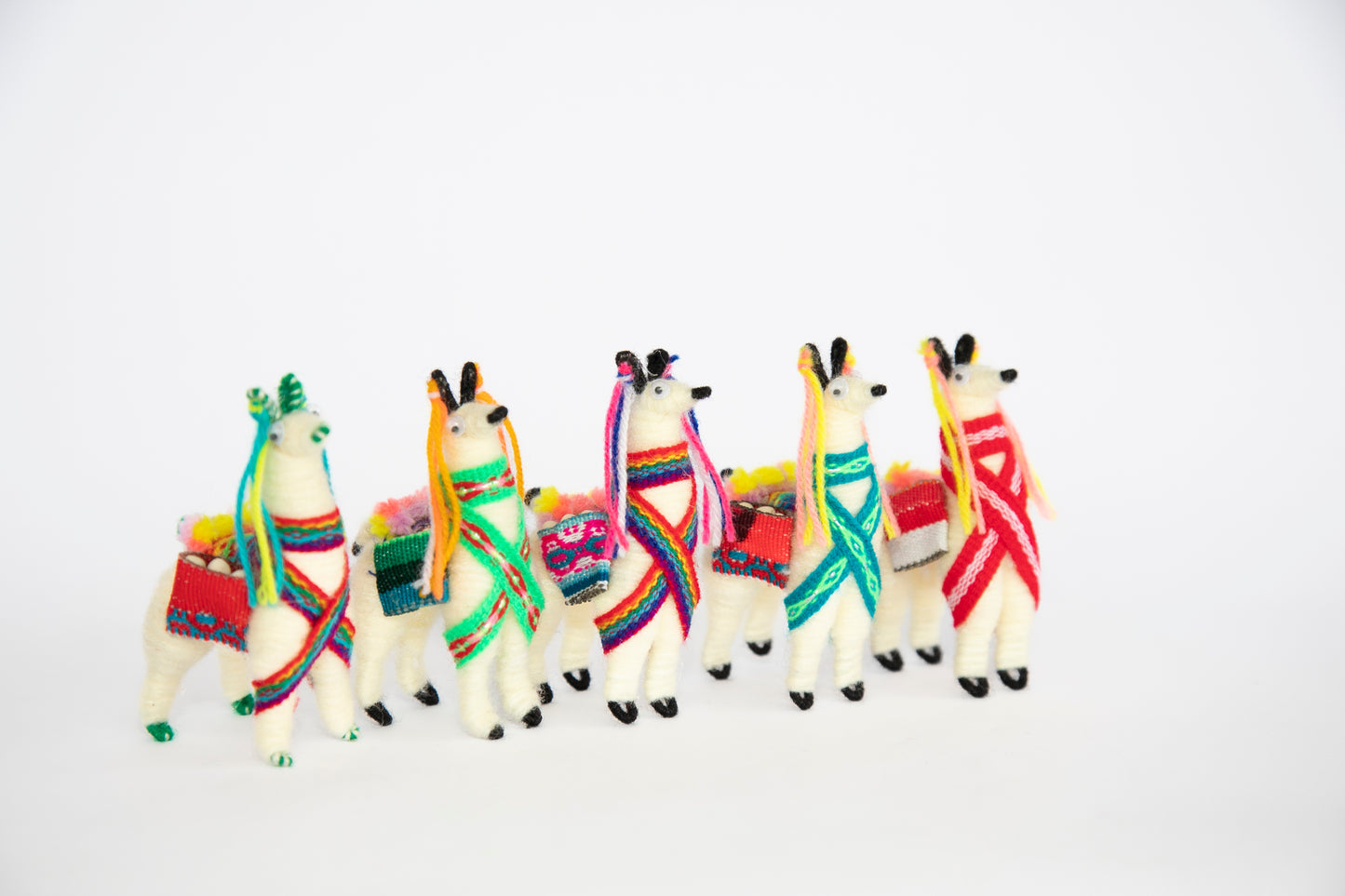 A Group of Small Llama Figurines Facing Right