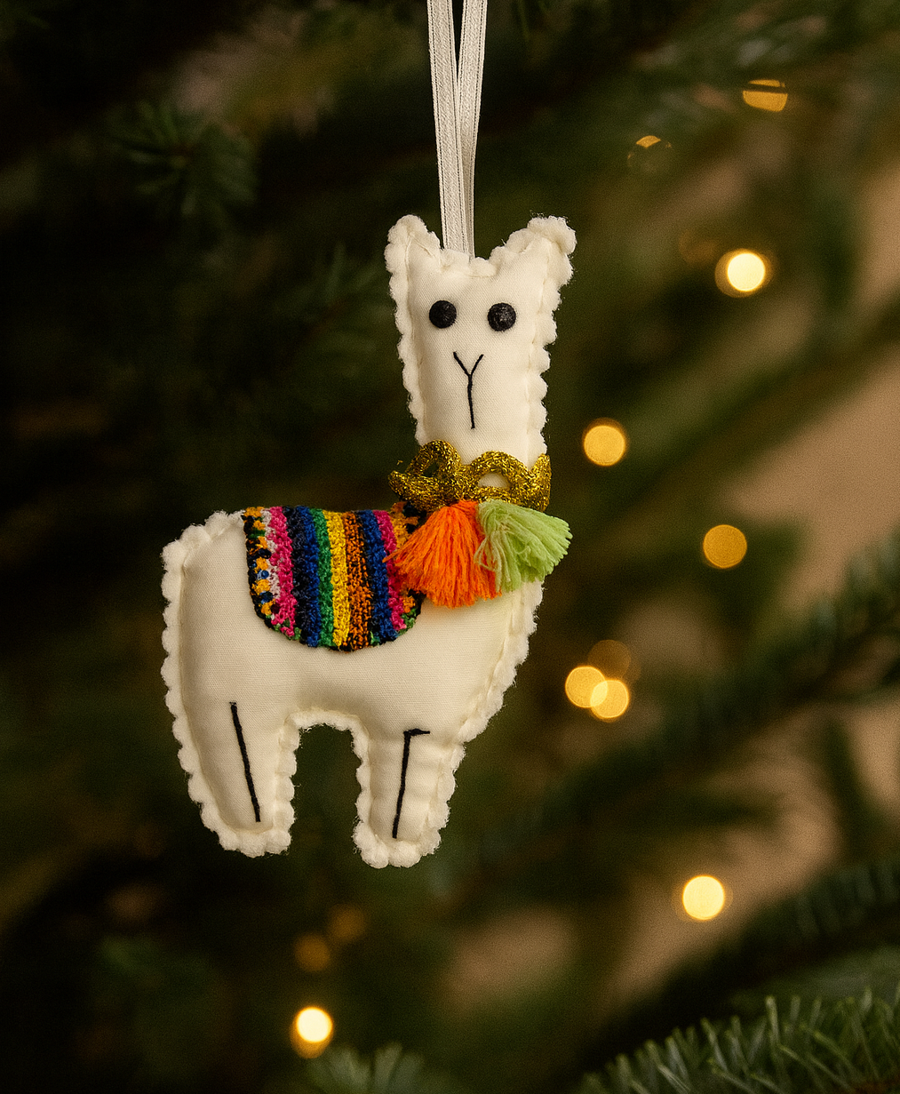 Decorative white llama ornament with a colorful scarf hanging on a Christmas tree.